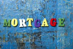 Mortgage word written of colorful wooden abc letter on abstract grounge background