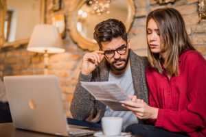 Young couple having bills to pay.