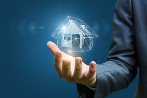 Real estate agent holding a model house on a blue background.