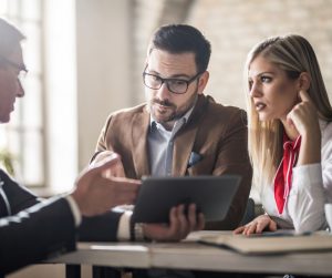 young-couple-and-their-real-estate-agent-looking-at-housing-plan-on-picture-id935259316