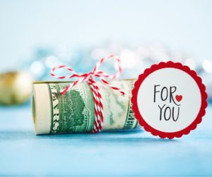 giving-the-gift-of-cash-for-the-christmas-picture-id1059443228