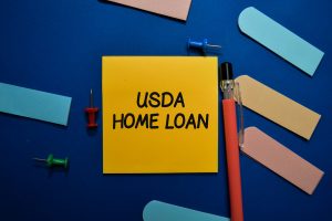 USDA Home Loan write on sticky note isolated on Office Desk.